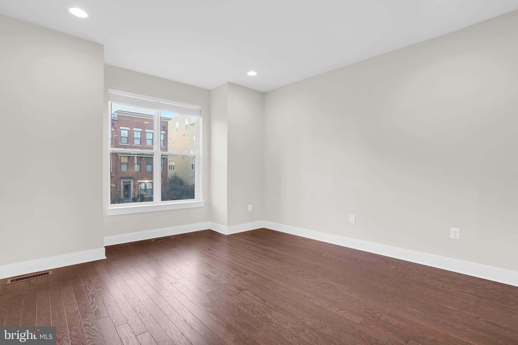 22954 Sullivans Cove Square Brambleton, VA 20148 - Photo 23 of 38 a view of an empty room with wooden floor and a window