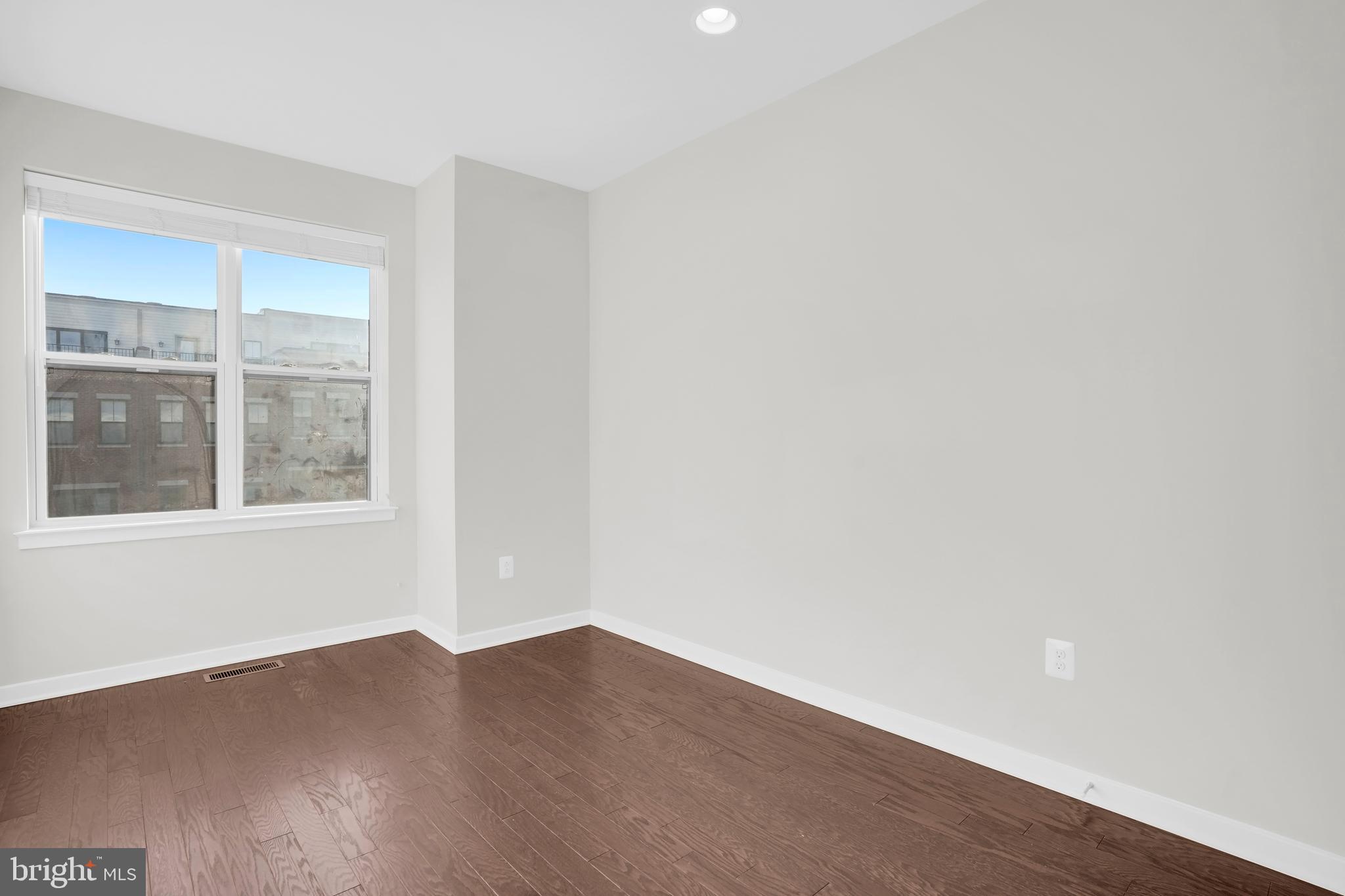 22954 Sullivans Cove Square Brambleton, VA 20148 - Photo 24 of 38 a view of an empty room with wooden floor and a window