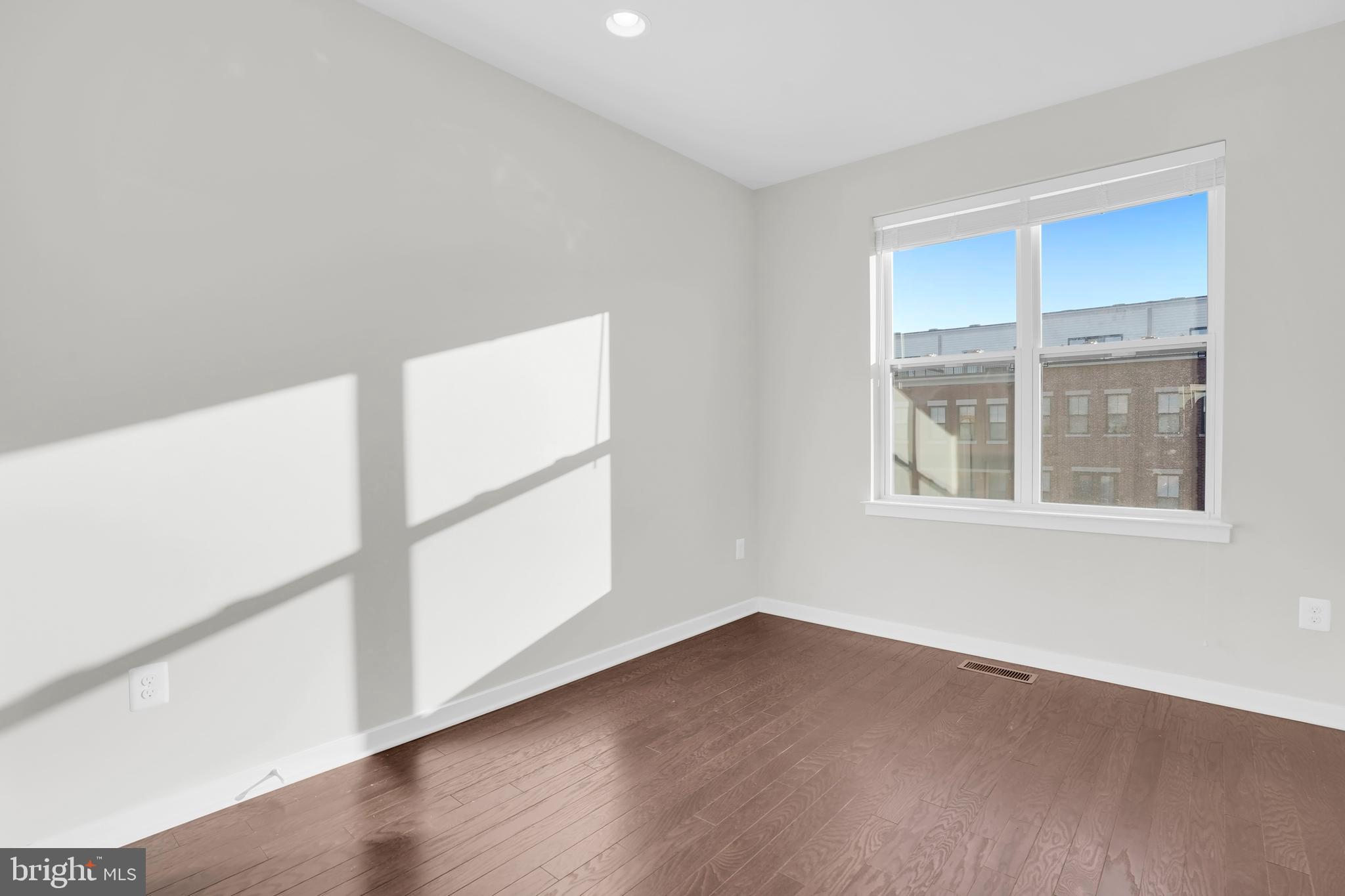 22954 Sullivans Cove Square Brambleton, VA 20148 - Photo 26 of 38 an empty room with wooden floor and windows