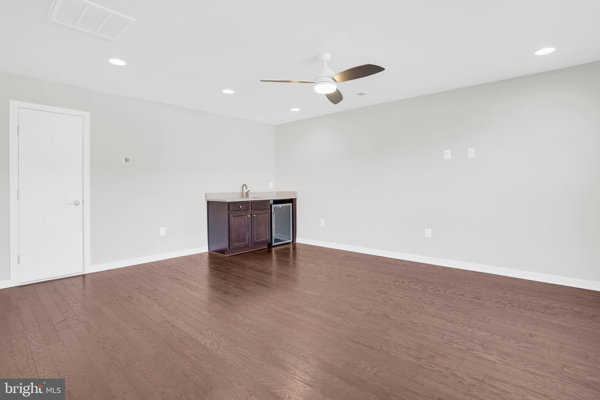 22954 Sullivans Cove Square Brambleton, VA 20148 - Photo 29 of 38 an empty room with wooden floor and windows