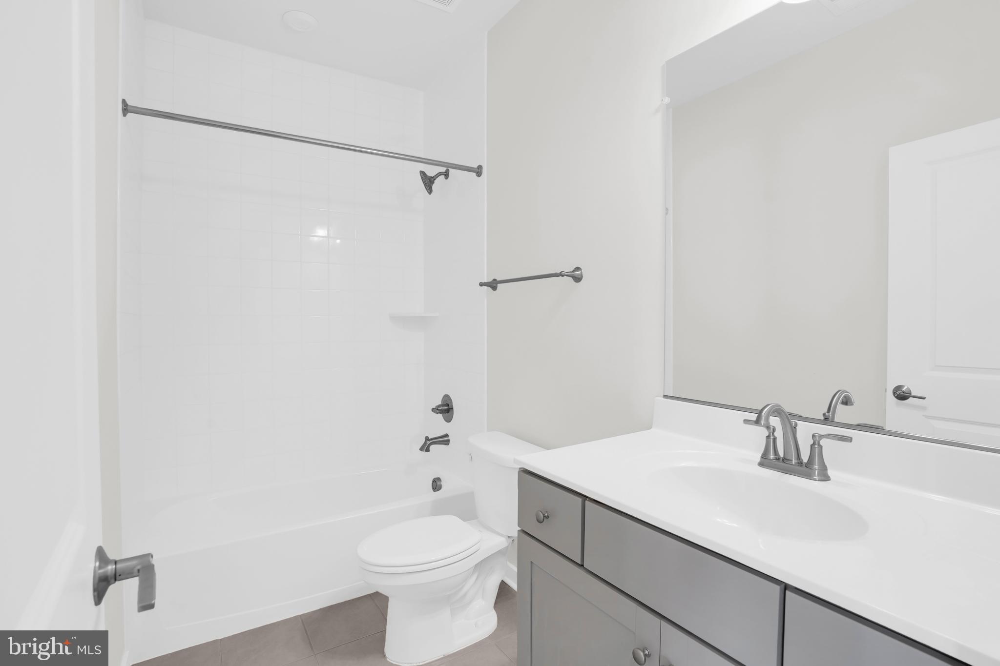 22954 Sullivans Cove Square Brambleton, VA 20148 - Photo 33 of 38 a bathroom with a sink a toilet and shower