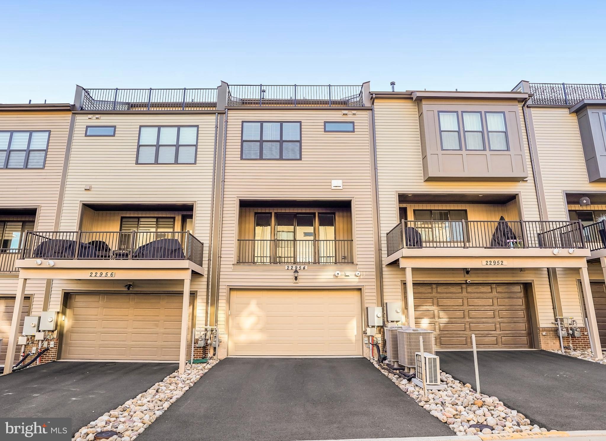 22954 Sullivans Cove Square Brambleton, VA 20148 - Photo 34 of 38 a front view of a building with many windows