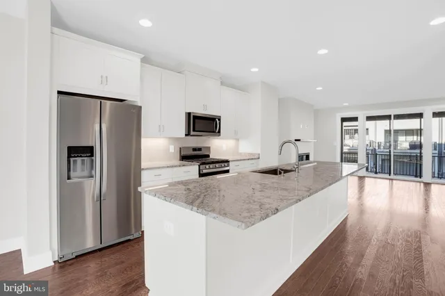 a kitchen with counter top space cabinets and stainless steel appliances
