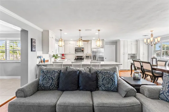 a living room with furniture and kitchen view