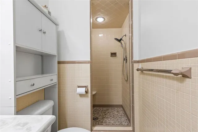a bathroom with a sink toilet vanity and mirror