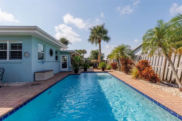 a view of a backyard with plants and a patio