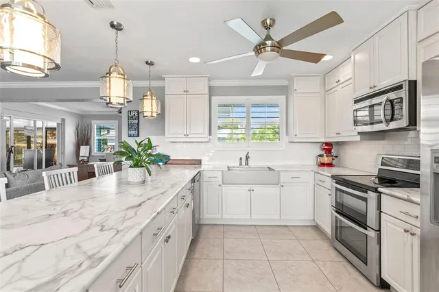 a kitchen with white cabinets and white appliances