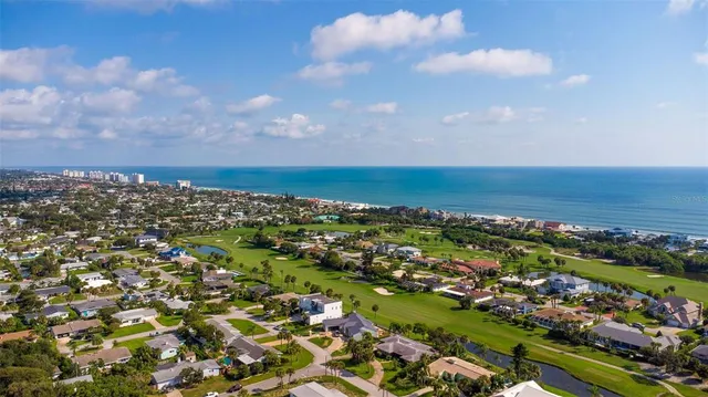 a view of a house with a backyard and a patio
