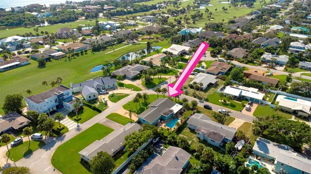 a view of a house with backyard and a patio