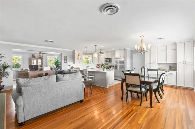 a living room with dining room and kitchen view