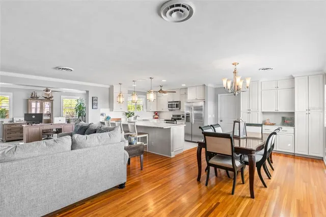 a view of a dining room with furniture and wooden floor