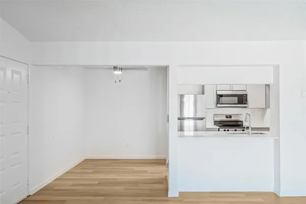 a kitchen with stainless steel appliances a refrigerator and microwave