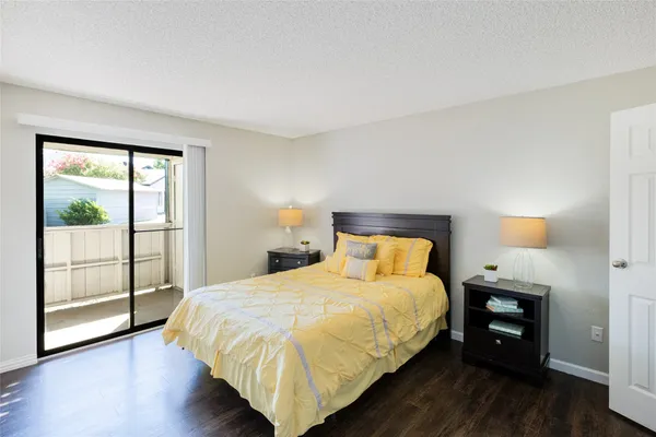 a large bed sitting in a bedroom next to a lamp