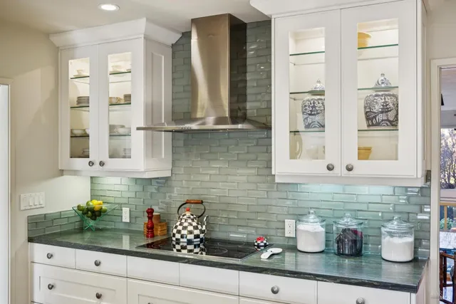 a rug with a painting on the wall and a plant