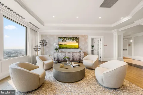 a living room with furniture and chandelier