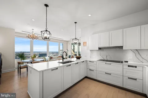 a kitchen with a sink a stove and cabinets