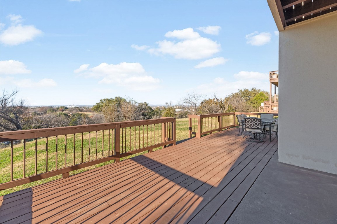 409 Hi There, Unit M Horseshoe Bay, TX 78657 - Photo 23 of 33 Wooden deck with outdoor dining area and a yard