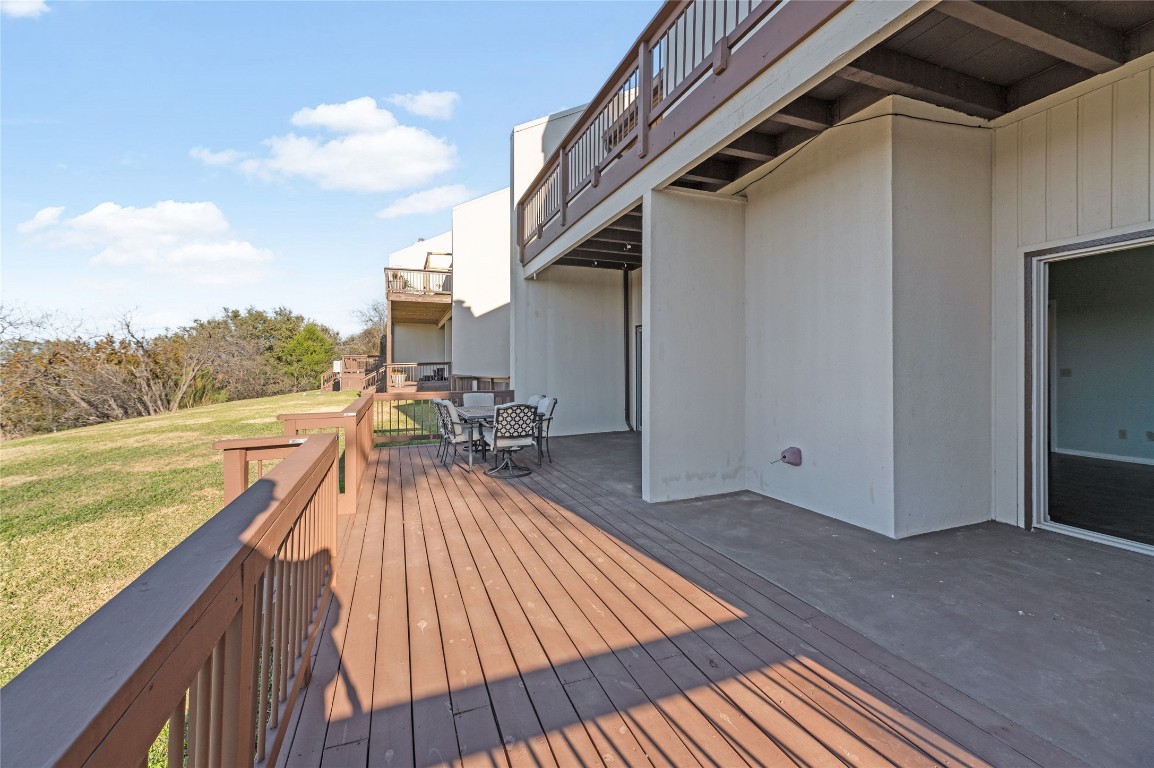 409 Hi There, Unit M Horseshoe Bay, TX 78657 - Photo 24 of 33 Wooden deck with outdoor dining space and a lawn