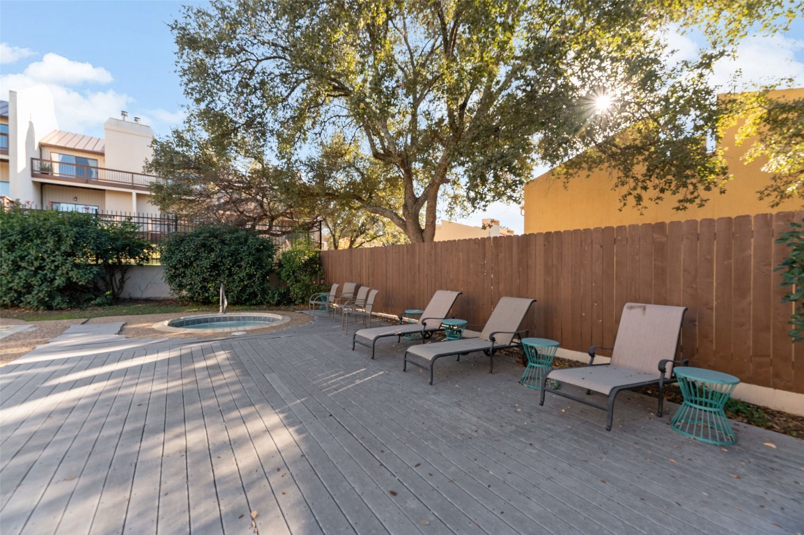 409 Hi There, Unit M Horseshoe Bay, TX 78657 - Photo 28 of 33 Wooden deck featuring an in-ground hot tub, a fenced backyard, and a patio