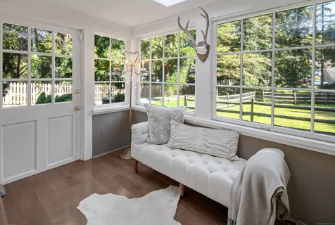 a living room with furniture and large window