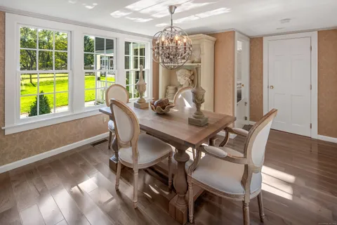 a kitchen with stainless steel appliances granite countertop a stove and a view of living room