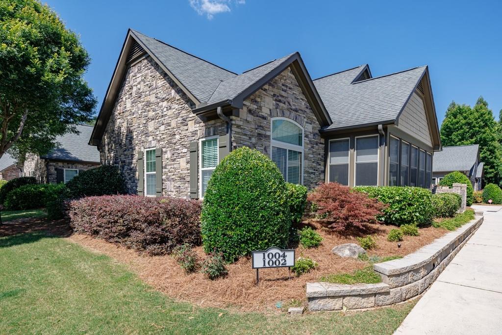 120 Chastain Road Northwest, Unit 1002 Kennesaw, GA 30144 - Photo 1 of 35 front view of a house with a yard