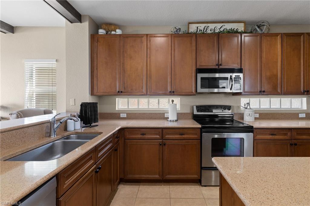 2104 Par Drive Naples, FL 34120 - Photo 15 of 37 a kitchen with a sink a stove and cabinets
