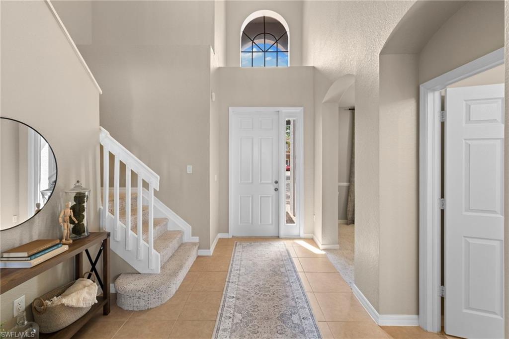 2104 Par Drive Naples, FL 34120 - Photo 16 of 37 a view of an entryway with wooden floor