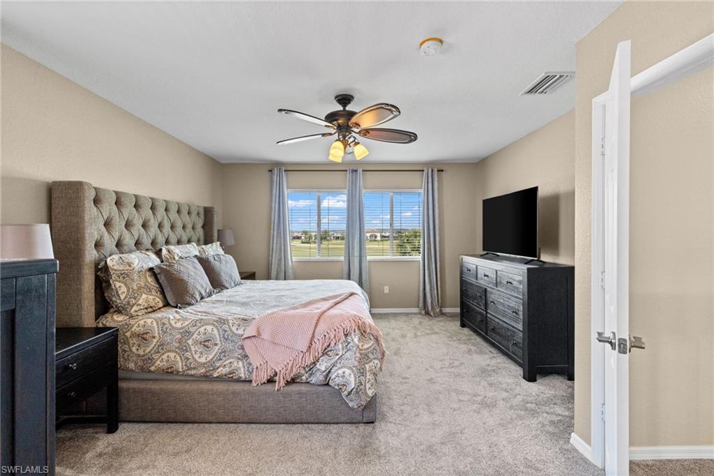 2104 Par Drive Naples, FL 34120 - Photo 17 of 37 a bedroom with a bed and a flat screen tv