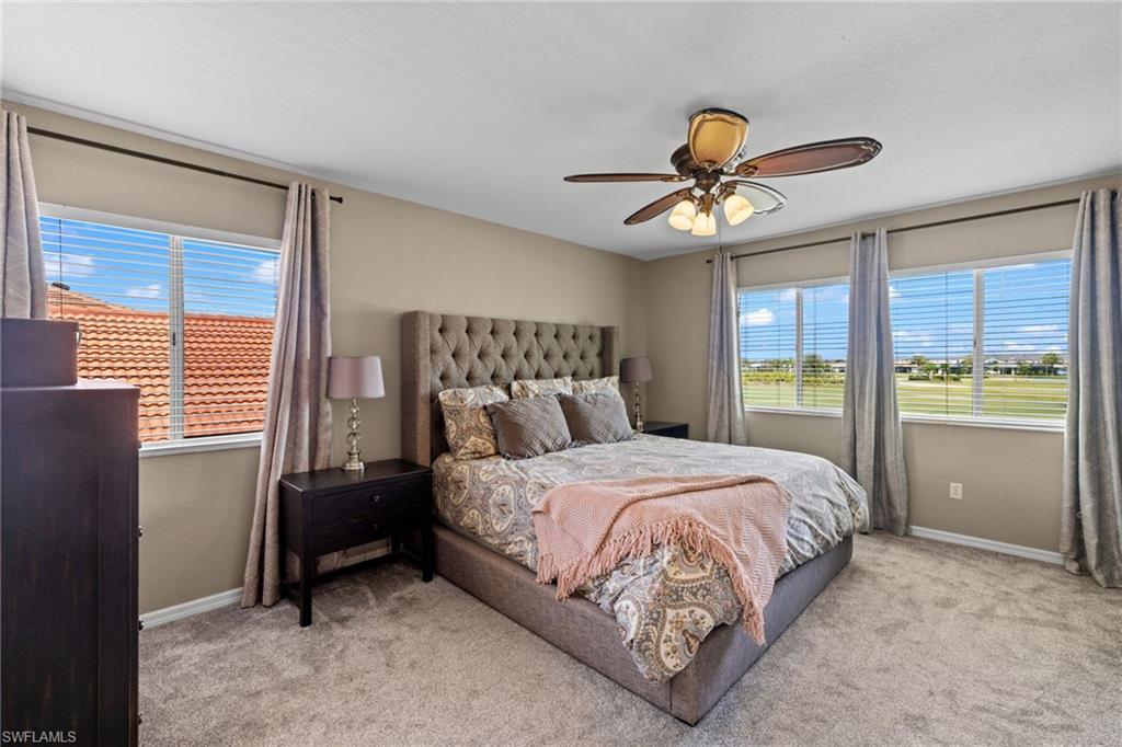 2104 Par Drive Naples, FL 34120 - Photo 18 of 37 a bedroom with a bed and a chandelier