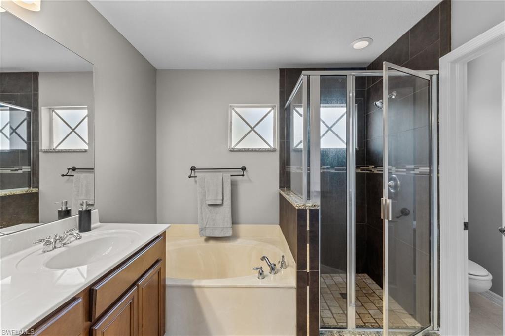 2104 Par Drive Naples, FL 34120 - Photo 19 of 37 a bathroom with a sink toilet and shower