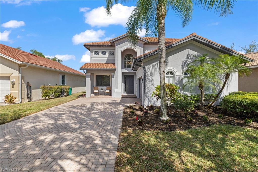 2104 Par Drive Naples, FL 34120 - Photo 2 of 37 a front view of a house with garden