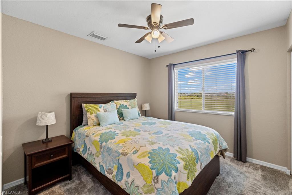 2104 Par Drive Naples, FL 34120 - Photo 21 of 37 a bedroom with a bed and a chandelier