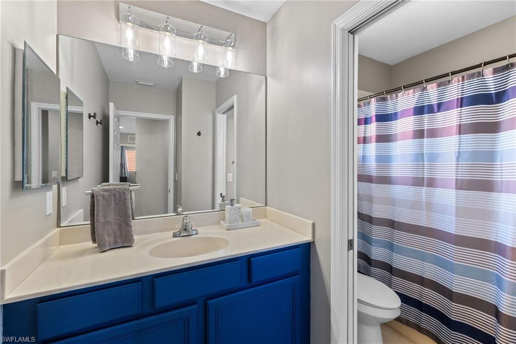 2104 Par Drive Naples, FL 34120 - Photo 22 of 37 a bathroom with a sink and a mirror