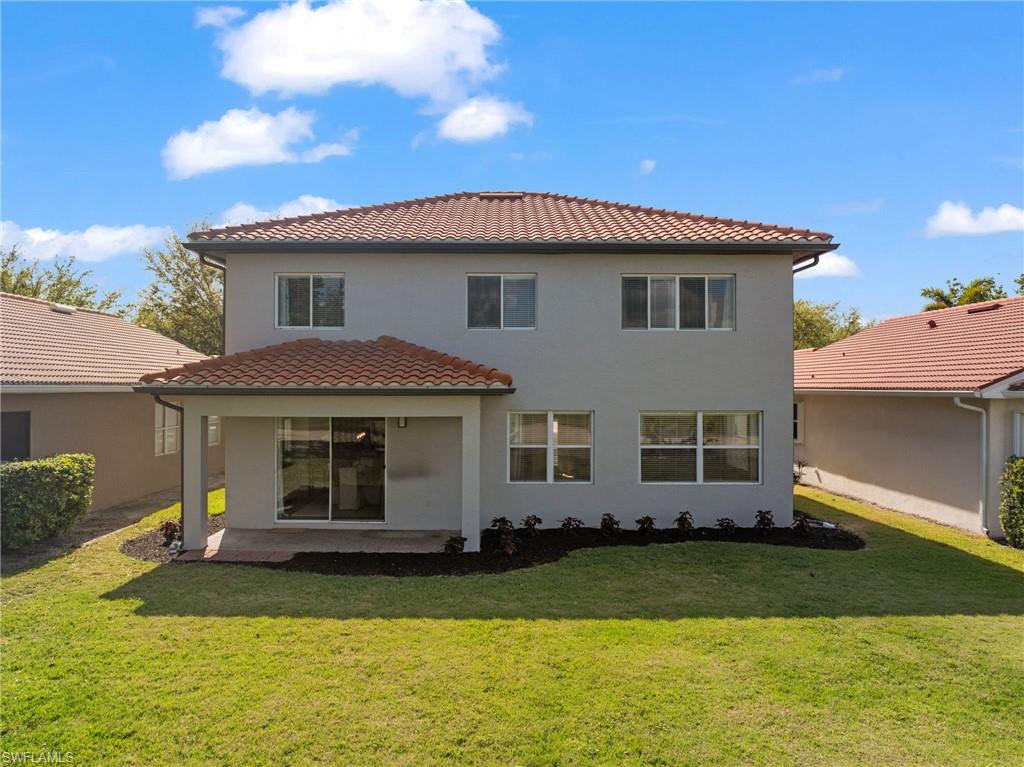 2104 Par Drive Naples, FL 34120 - Photo 36 of 37 a front view of a house with a garden