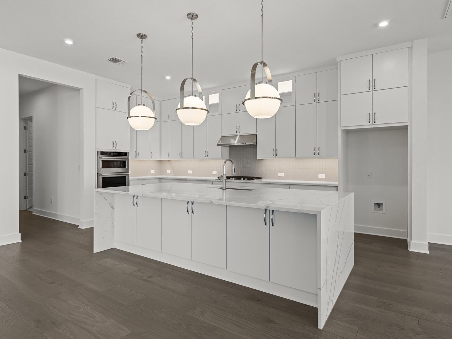 2508 Chiavari Way Leander, TX 78641 - Photo 10 of 24 A well-lit culinary space showcases a pristine kitchen island and modern pendant lighting.