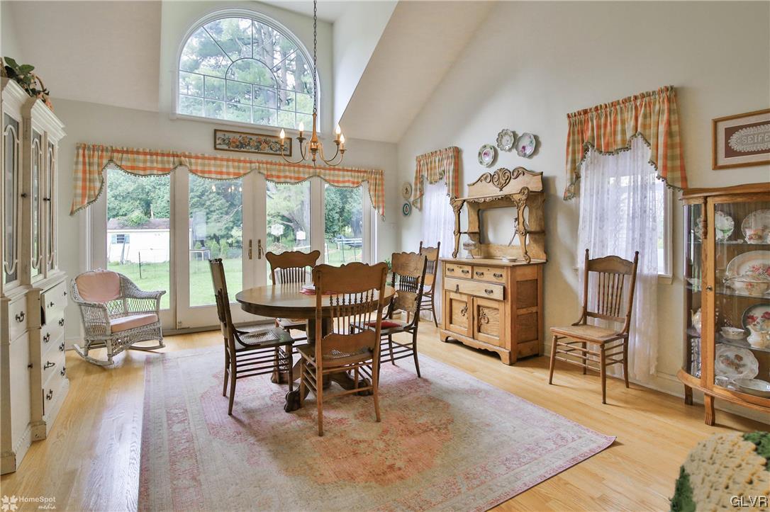 475 English Road Bath, PA 18014 - Photo 8 of 46 a dining room with furniture a floor to ceiling window and wooden floor