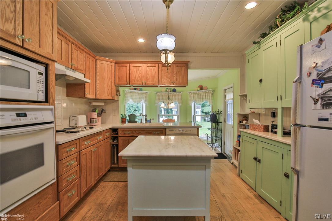 475 English Road Bath, PA 18014 - Photo 10 of 46 a kitchen with granite countertop a stove a sink dishwasher and a refrigerator with wooden floor