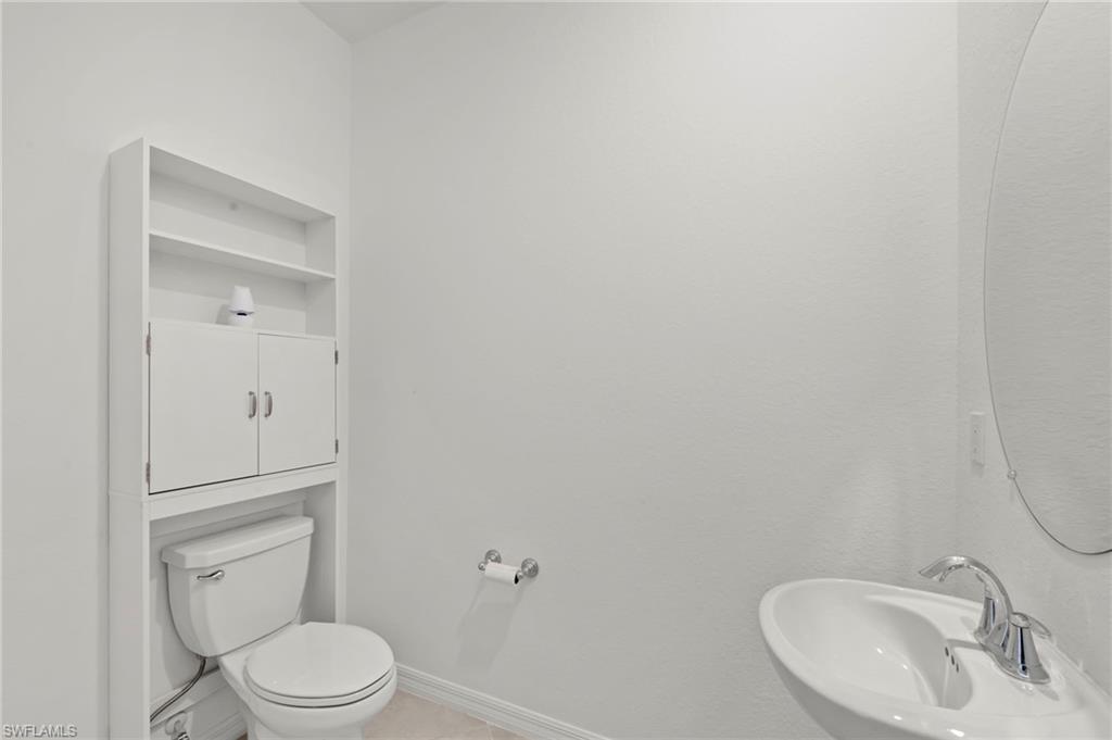 2827 Blossom Way Naples, FL 34120 - Photo 11 of 34 Half bath featuring toilet and a sink