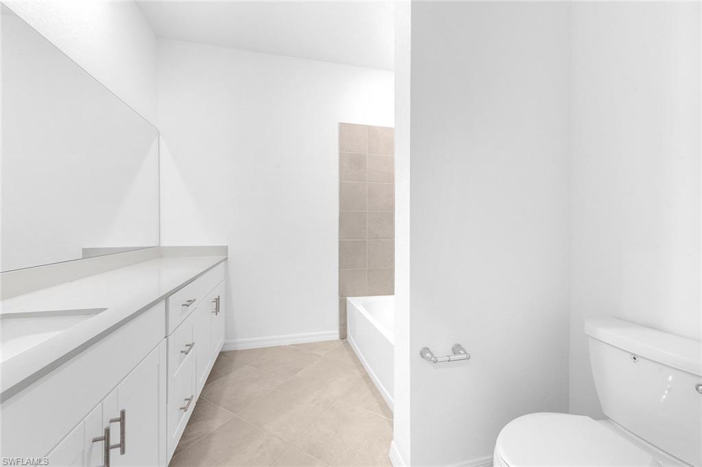 2827 Blossom Way Naples, FL 34120 - Photo 13 of 31 Bathroom featuring vanity and light tile patterned flooring