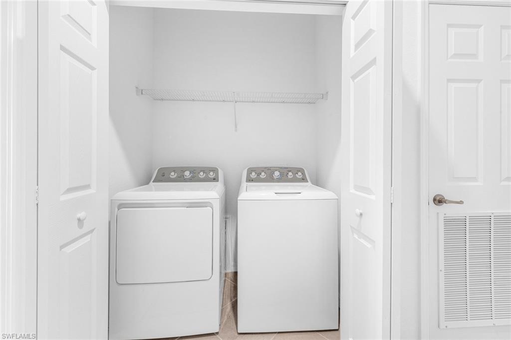 2827 Blossom Way Naples, FL 34120 - Photo 15 of 31 Laundry area with washing machine and dryer