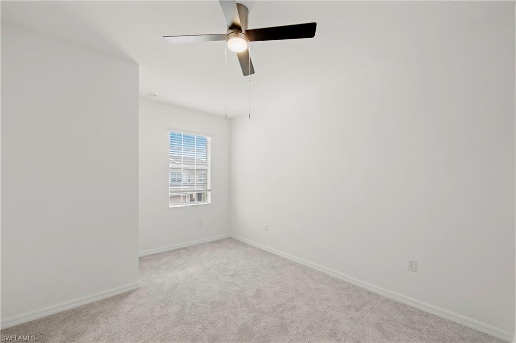 2827 Blossom Way Naples, FL 34120 - Photo 15 of 34 Unfurnished room with carpet and a ceiling fan