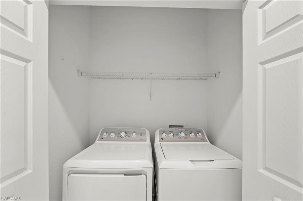 2827 Blossom Way Naples, FL 34120 - Photo 17 of 34 Laundry area with washing machine and dryer