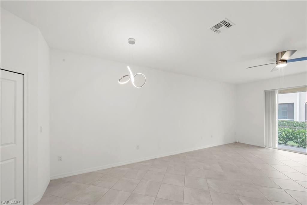 2827 Blossom Way Naples, FL 34120 - Photo 2 of 34 Empty room featuring a ceiling fan and light tile patterned floors