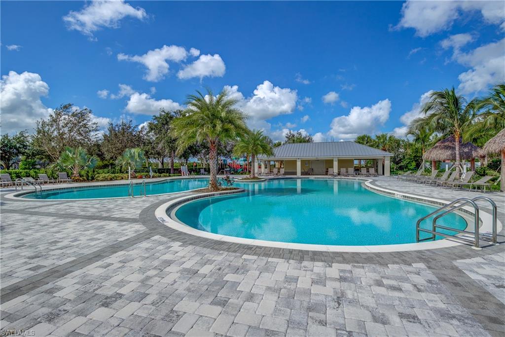 2827 Blossom Way Naples, FL 34120 - Photo 22 of 34 Community pool featuring a patio