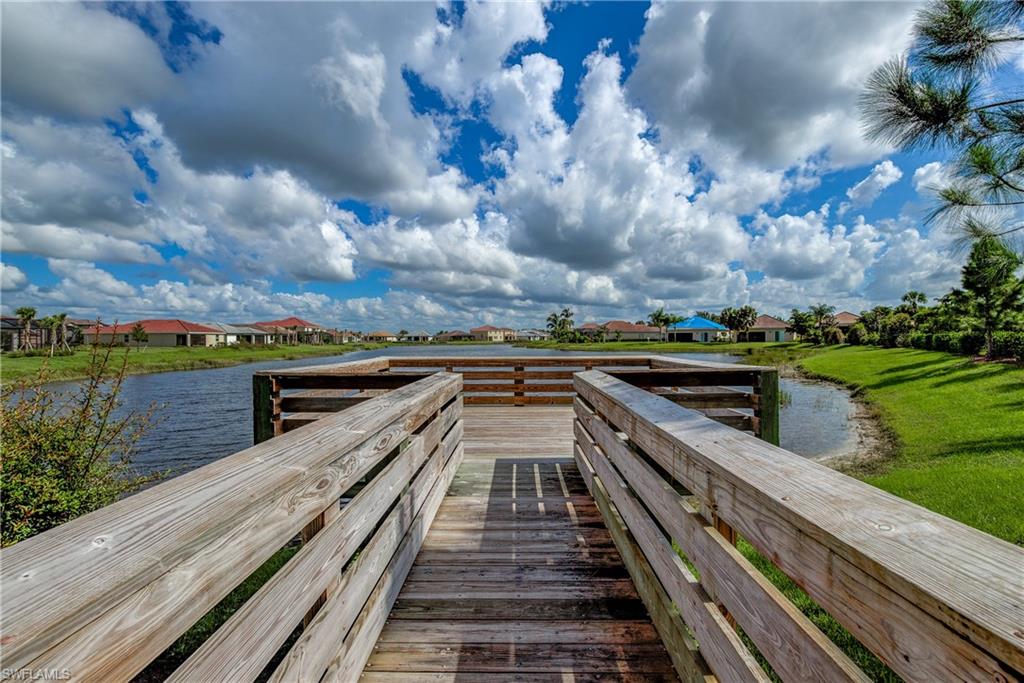2827 Blossom Way Naples, FL 34120 - Photo 31 of 31 Dock area featuring a residential view and a water view