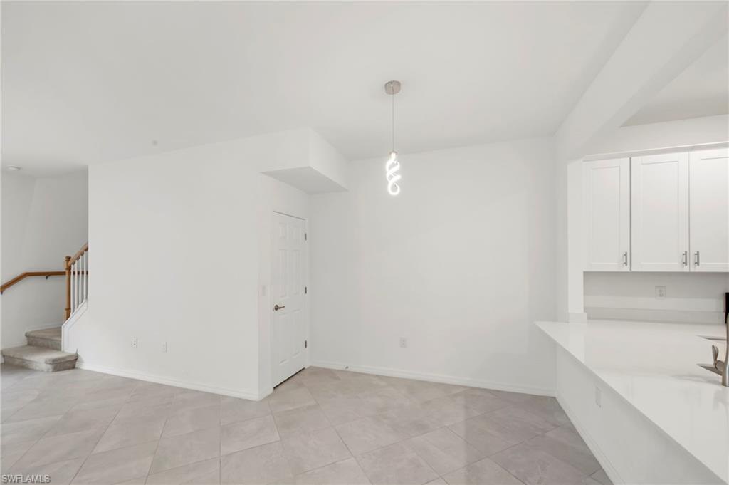 2827 Blossom Way Naples, FL 34120 - Photo 4 of 34 Unfurnished dining area with light tile patterned flooring