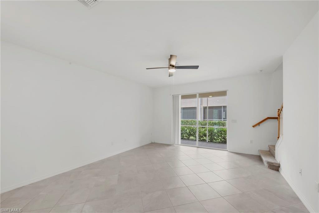 2827 Blossom Way Naples, FL 34120 - Photo 6 of 34 Empty room featuring light tile patterned floors and ceiling fan