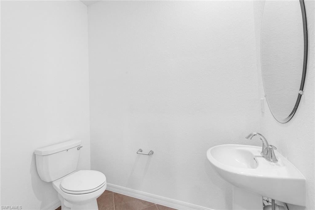 2827 Blossom Way Naples, FL 34120 - Photo 7 of 31 Bathroom featuring toilet and tile patterned flooring