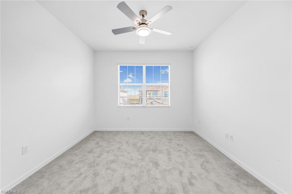 2827 Blossom Way Naples, FL 34120 - Photo 8 of 31 Unfurnished room featuring light colored carpet and ceiling fan